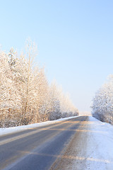 Image showing Winter road through snowy forests