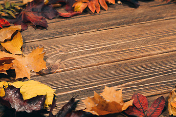 Image showing Background with wooden table and autumnal leaves