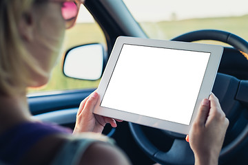 Image showing Woman using tablet pc in the car