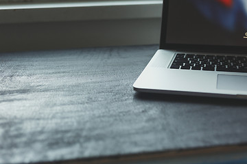 Image showing Laptop on modern wooden desk 