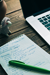 Image showing Workplace with open laptop on modern wooden desk 