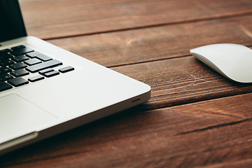 Image showing Close-up shot of laptop on old wooden desk