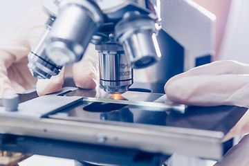 Image showing Scientist hands with microscope