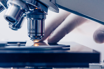 Image showing Scientist hands with microscope