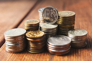 Image showing Top view coins on old wooden desk with copy space on top.