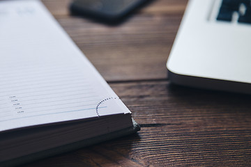 Image showing Laptop and diary on the desk