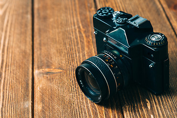 Image showing Old camera and on wooden table