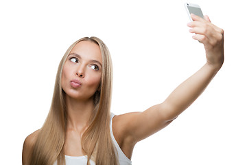 Image showing beautiful woman make selfie on white background