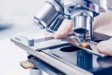 Image showing Scientist hands with microscope