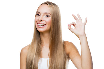 Image showing Young woman shows gesture ok on white background