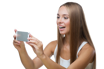 Image showing Woman taking pictures of something on the phone