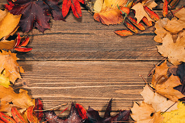 Image showing Background with wooden table and autumnal leaves