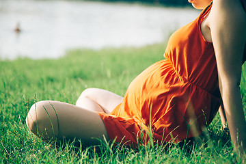 Image showing Pregnant woman, holding in hands bouquet of daisy 