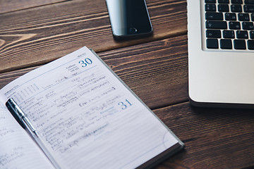 Image showing Laptop and diary on the desk