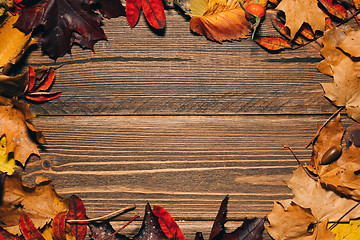 Image showing Background with wooden table and autumnal leaves