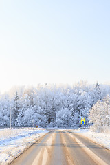 Image showing Winter road through snowy fields and forests