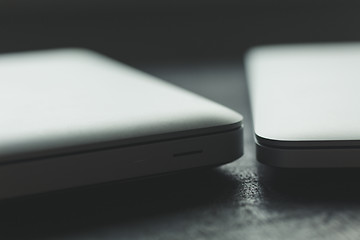 Image showing Two closed laptops on modern wooden desk 