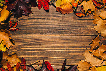 Image showing Background with wooden table and autumnal leaves