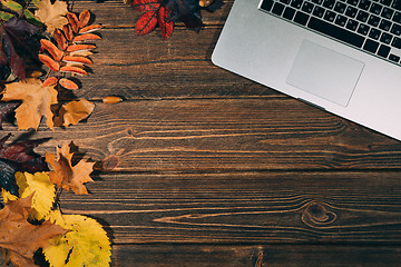 Image showing Background with laptop and autumnal leaves