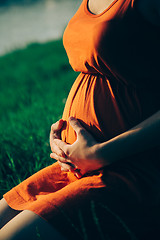 Image showing Pregnant woman, holding in hands bouquet of daisy 