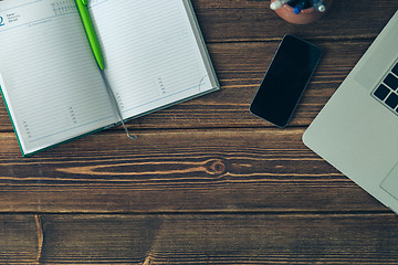 Image showing Laptop and diary on the desk