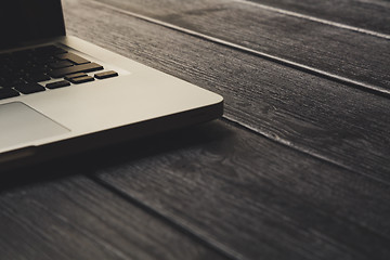 Image showing Laptop on modern wooden desk 