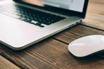 Image showing Workplace with open laptop on modern wooden desk 