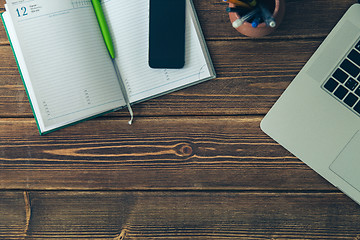 Image showing Laptop and diary on the desk