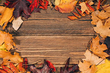 Image showing Background with wooden table and autumnal leaves