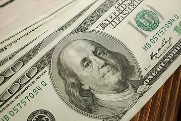 Image showing Bundle of money on wooden background