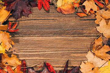 Image showing Background with wooden table and autumnal leaves