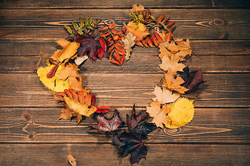 Image showing Background with wooden table and autumnal leaves