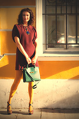 Image showing beautiful middle-aged woman in a burgundy dress