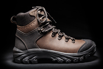 Image showing New hiking boot. Isolated on black