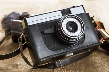 Image showing Vintage photo camera and blank film strip 