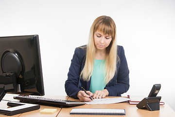 Image showing Office worker enthusiastically studying a paper document