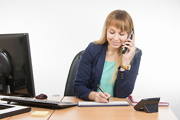 Image showing Business woman talking on the phone records in a notebook date business meeting