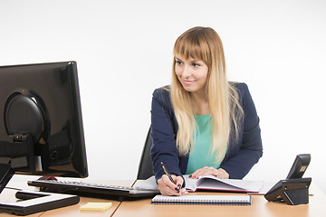 Image showing Business woman writes in diary appointment reminder