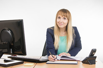 Image showing Business woman writing a note in the diary