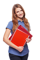 Image showing Young woman holding textbooks