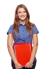 Image showing Young woman holding textbooks