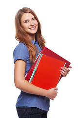 Image showing Young woman holding textbooks