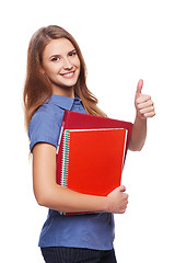 Image showing Young woman holding textbooks