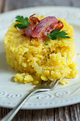 Image showing Saffron risotto garnished with bacon and parsley.