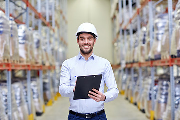 Image showing happy businessman with clipboard at warehouse