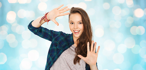 Image showing happy smiling pretty teenage girl showing hands