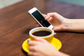 Image showing close up of woman with smartphone and coffee