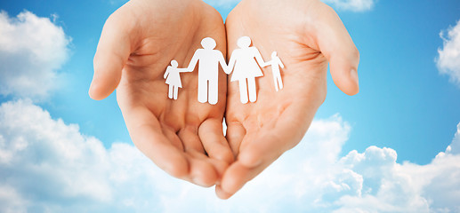 Image showing man hands holding paper cutout of family