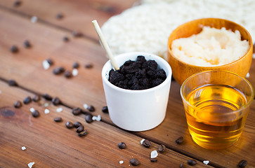 Image showing close up of coffee scrub in cup and honey on wood