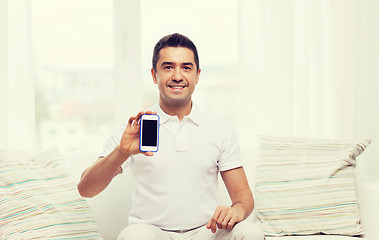 Image showing happy man with smartphone at home